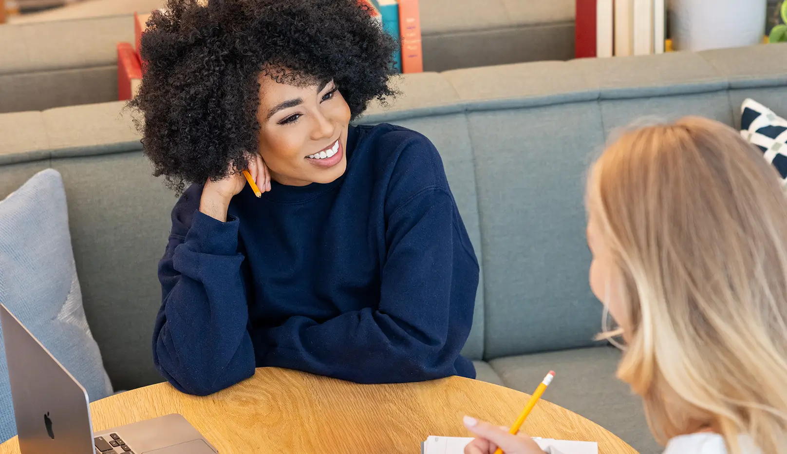 two young women studying together