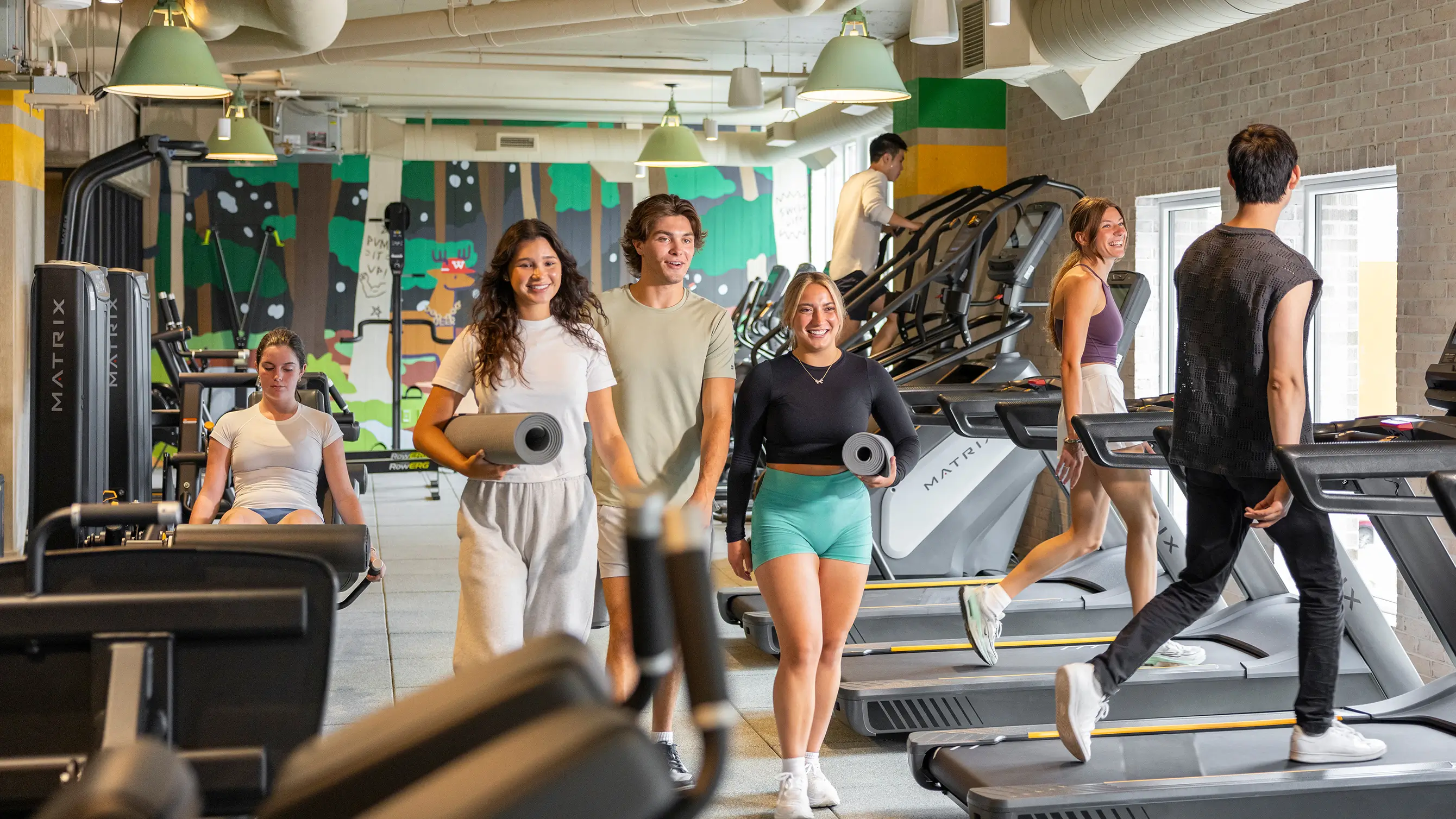a group of friends walking in a fitness center