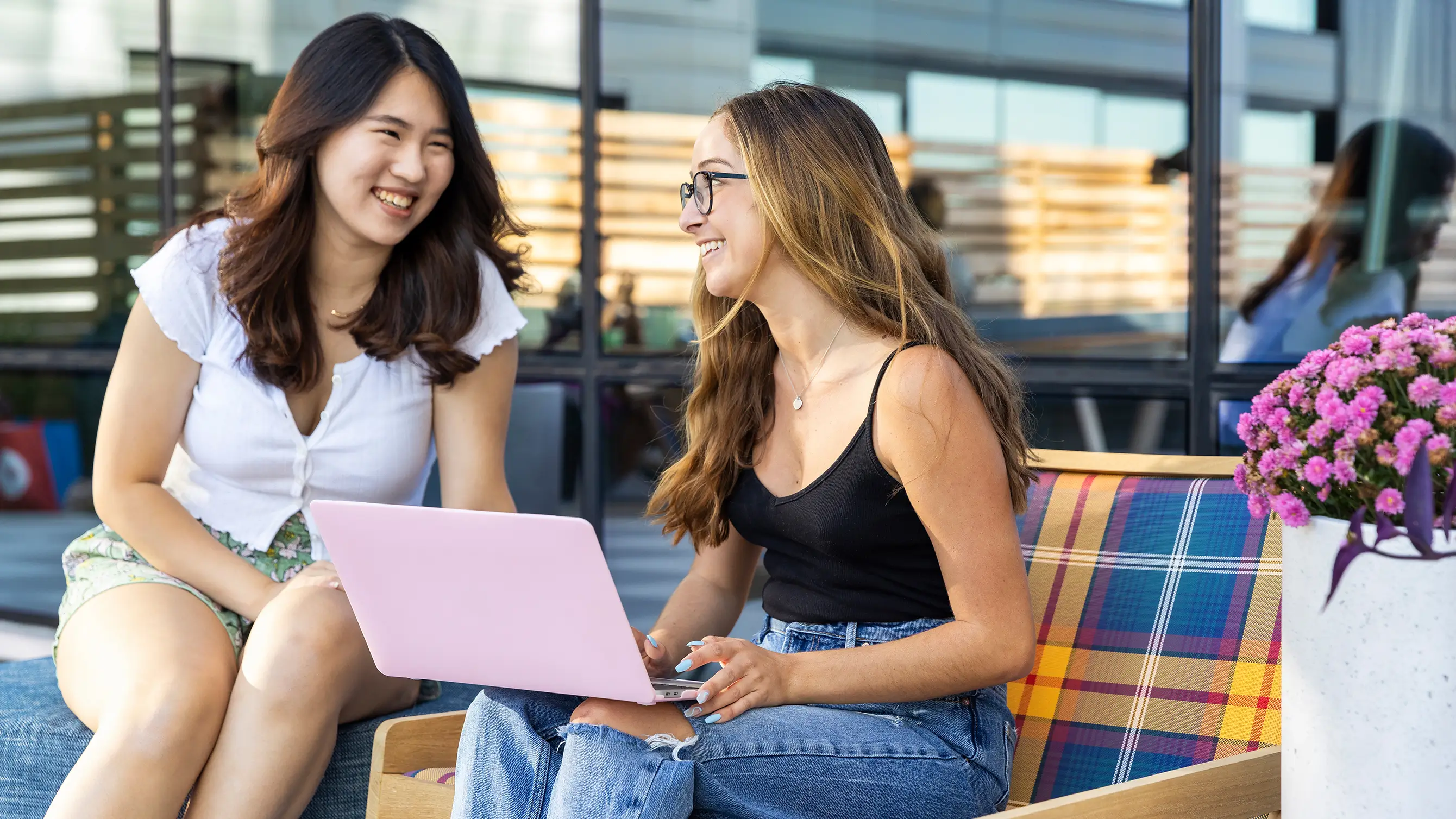 two women looking at a laptop